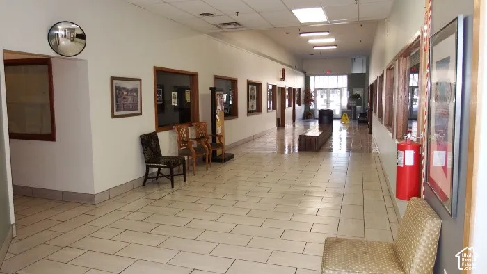 Tile flooring, recessed lighting, drop ceiling, white walls, wood-framed interior windows