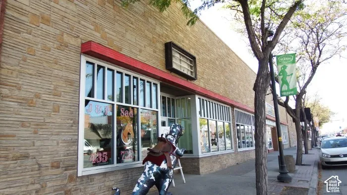 Stacked stone facade with large storefront windows and a red awning