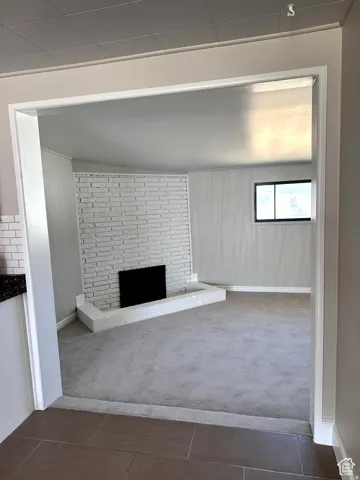 White painted brick fireplace with a black insert