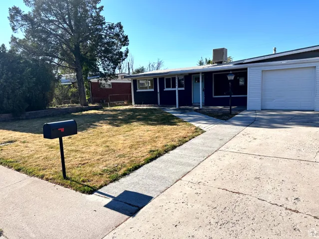 Single-story residence featuring a two-tone exterior, attached garage, and concrete driveway