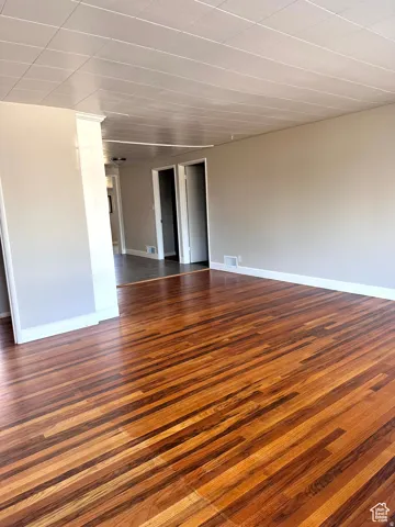 Wood-finish flooring, neutral wall paint, and white trim