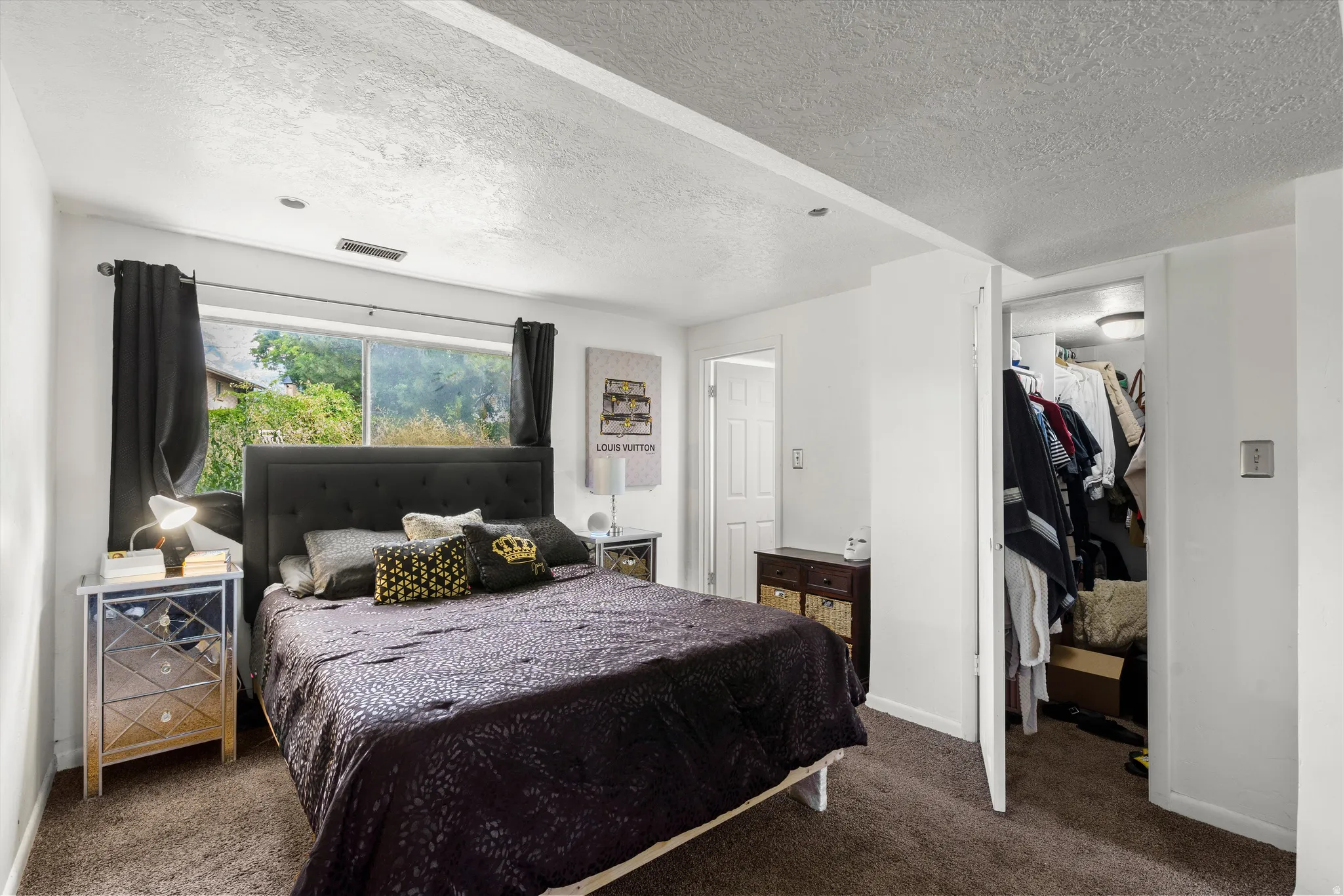 Carpeted flooring, window with exterior view, recessed lighting, and an open closet