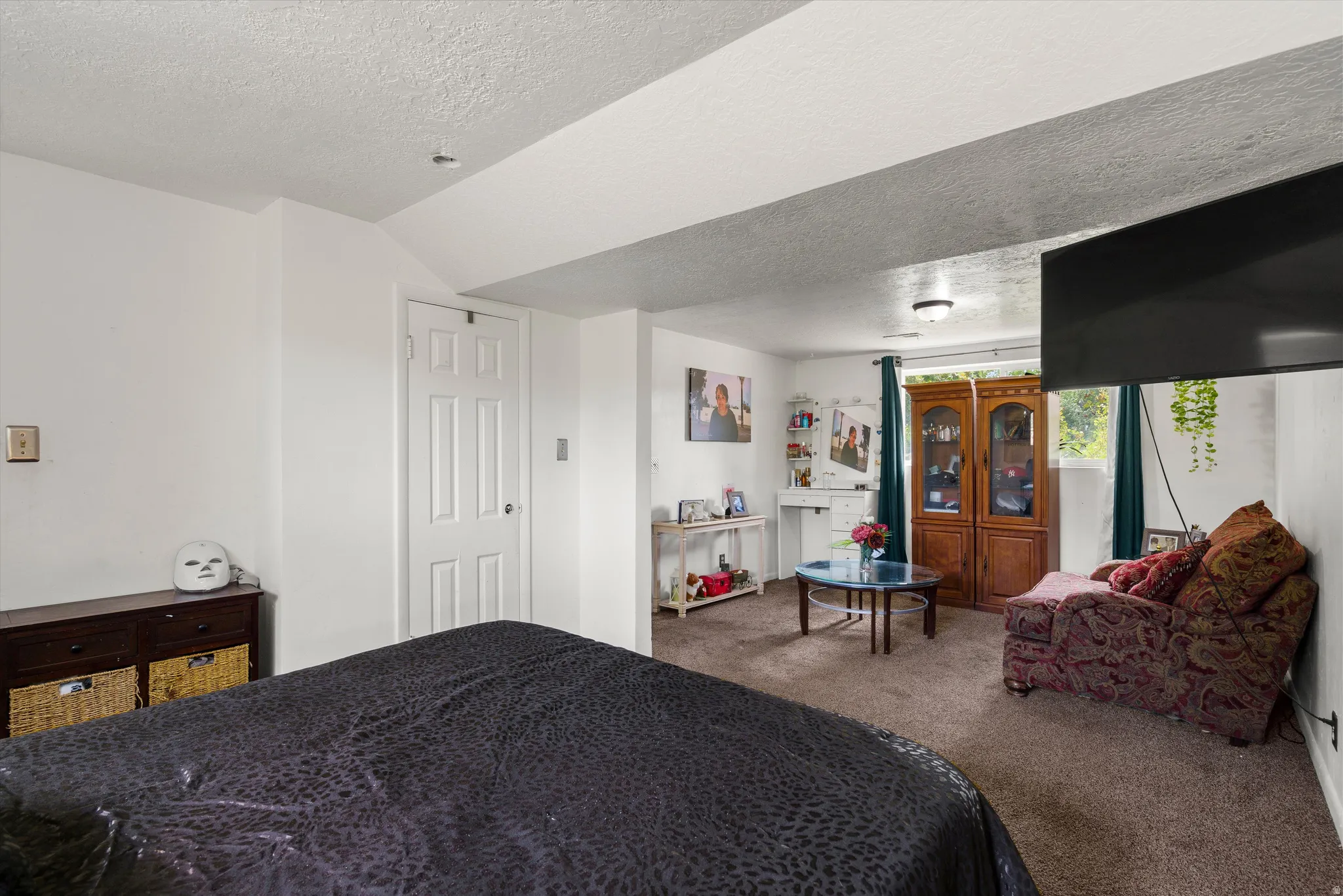 Carpeted flooring, recessed lighting, and a paneled door