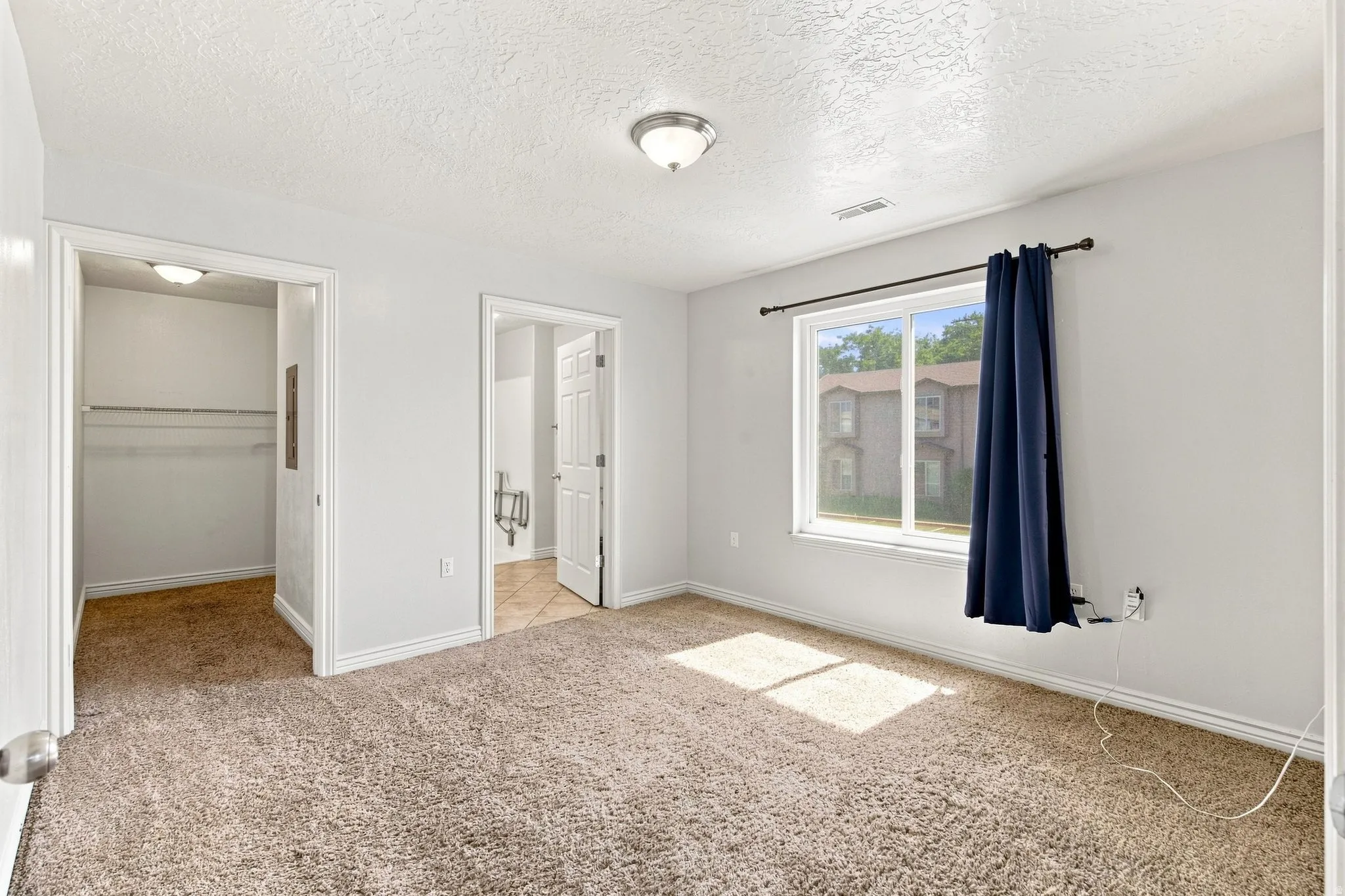 Master bedroom on the main floor. The accessible bathroom is on the right, and the walk-in closet is on the left.