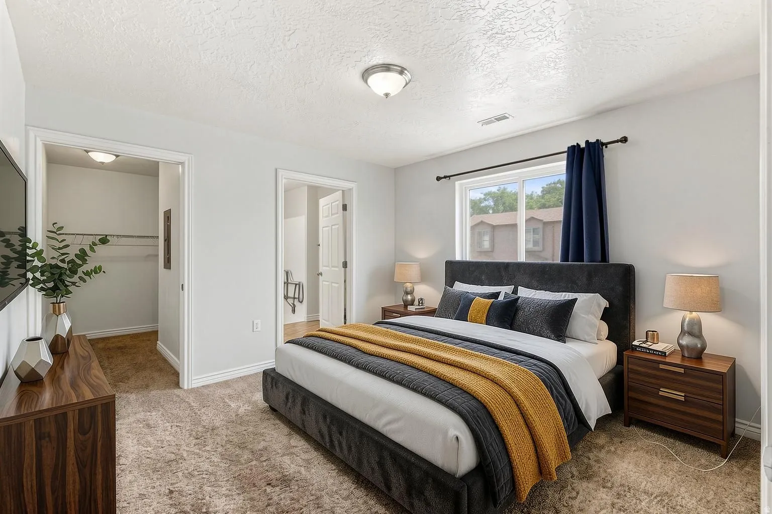 Master bedroom on the main floor. The accessible bathroom is on the right, and the walk-in closet is on the left.