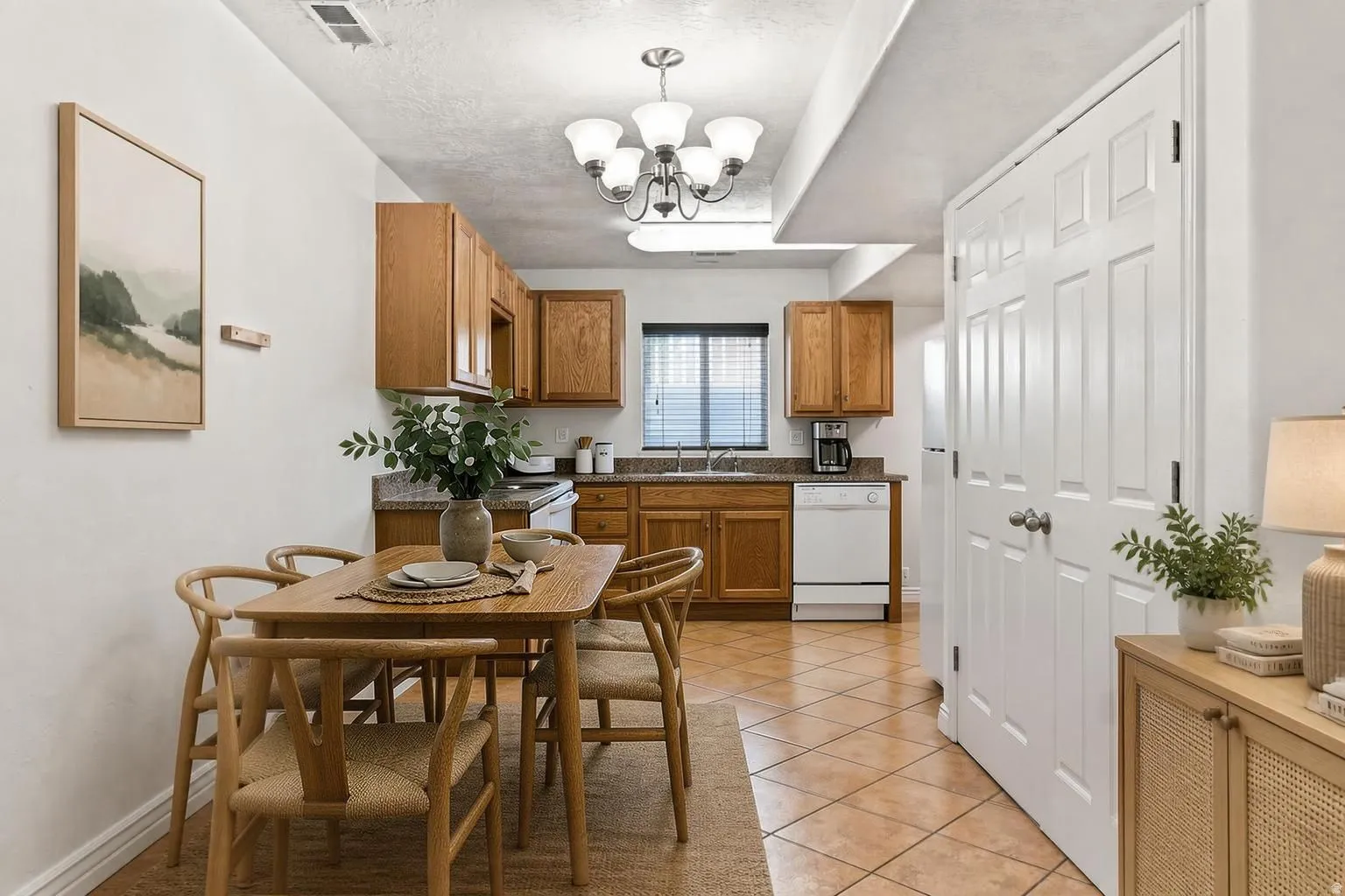 Basement apartment Dining/Kitchen. To the right behind the doors is the utilities for both the furnace and Water heater. This picture has been virtually staged.