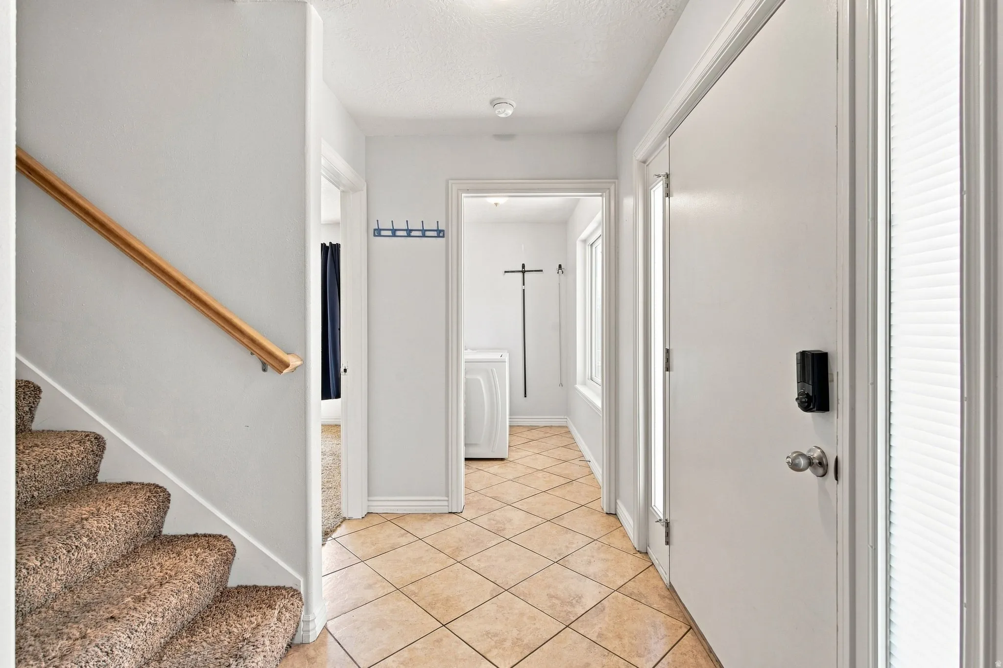 Main floor entry, Straight ahead is the laundry room, to the left is the master bedroom. Upstairs are two additional guest bedrooms.