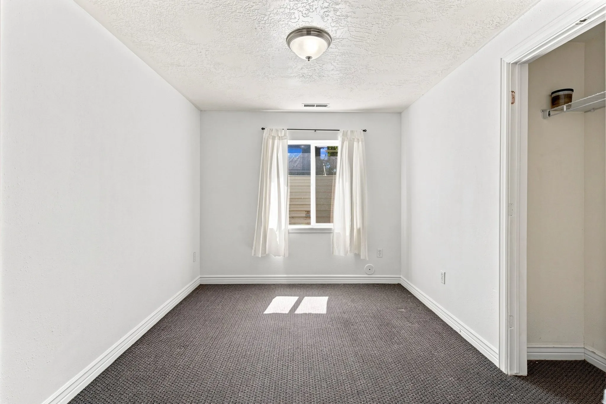 This is one of the two basement apartment bedrooms. This bedroom is behind the stairs to the right of the laundry room.