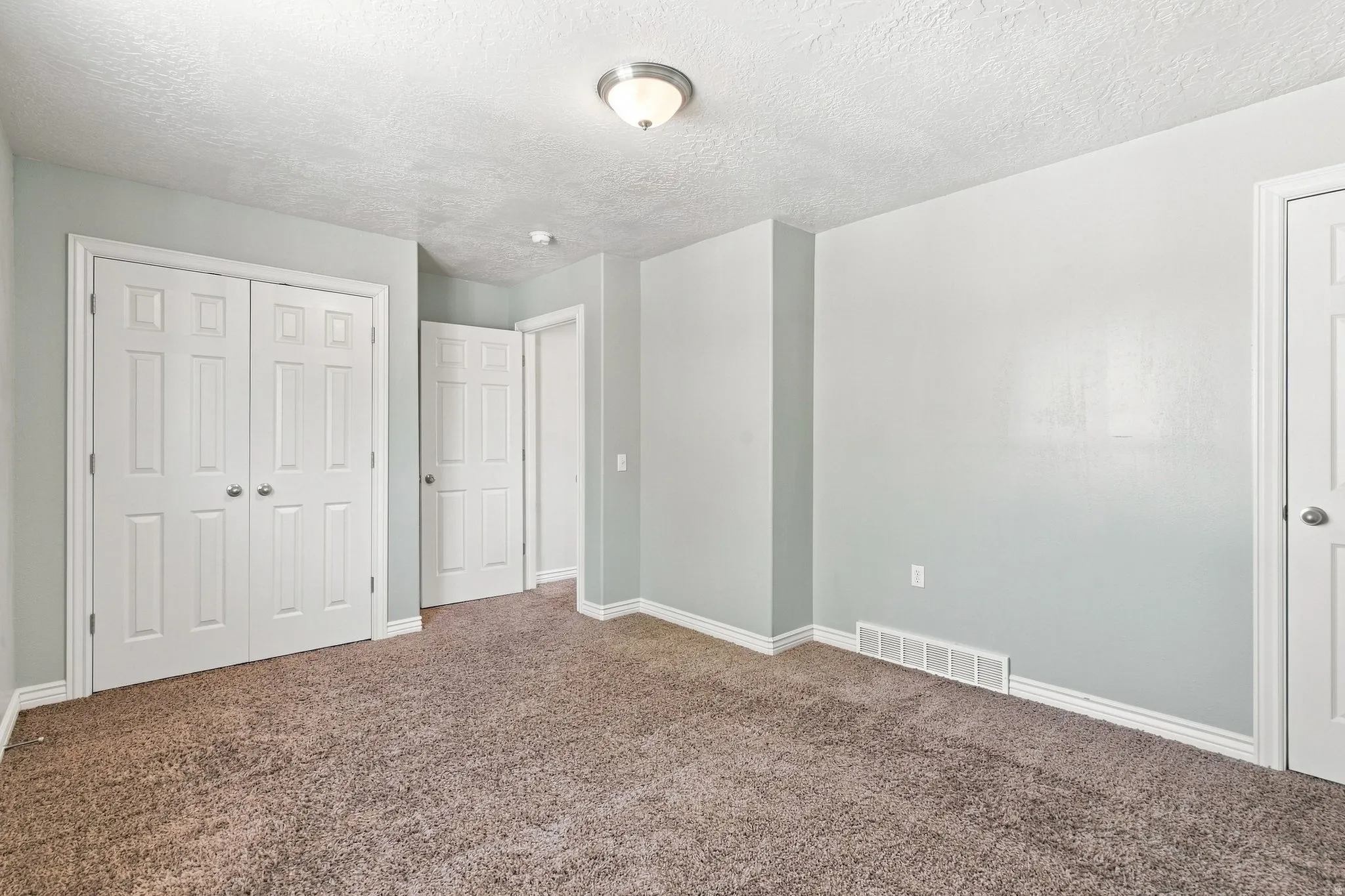 This is one of two basement apartment bedrooms. This bedroom features two large closet's.
