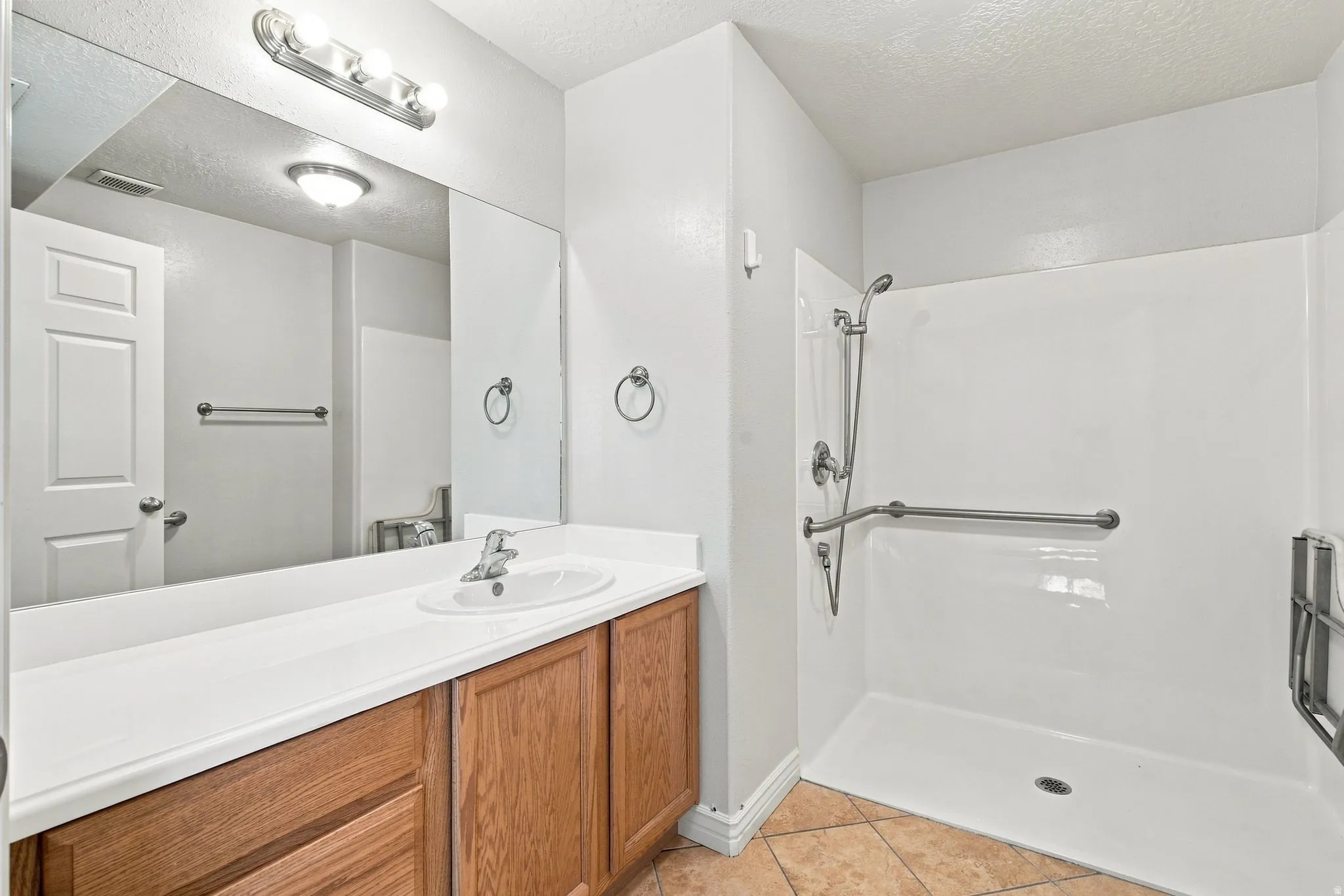 walk-in master shower, vanity and open counter.