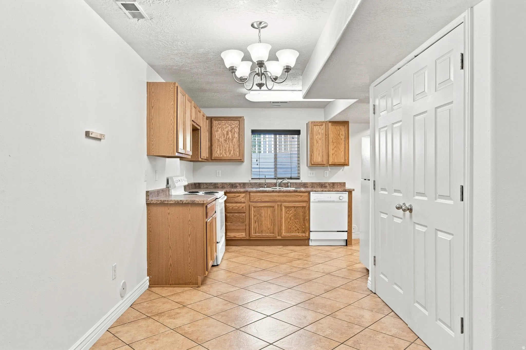 Basement apartment Dining/Kitchen. To the right behind the doors is the utilities for both the furnace and Water heater.