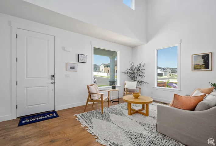 Expansive interior with high ceilings and wood-finish flooring