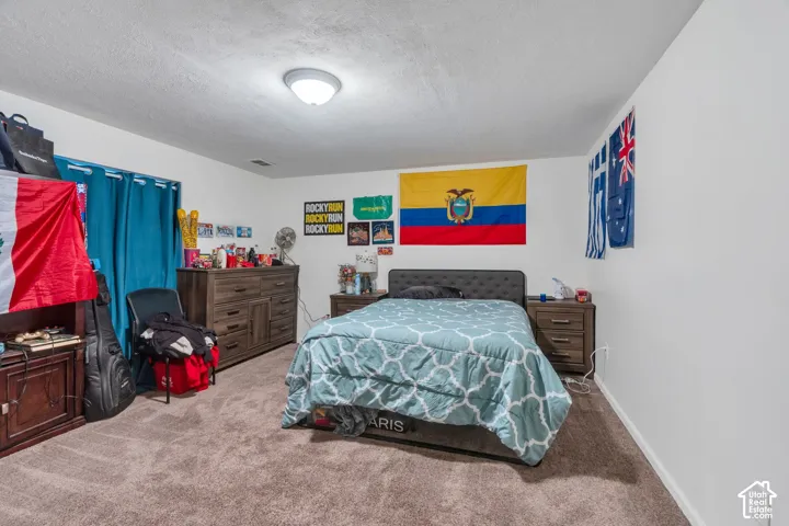 Bedroom featuring neutral walls, carpeting, and a flush-mount ceiling light fixture