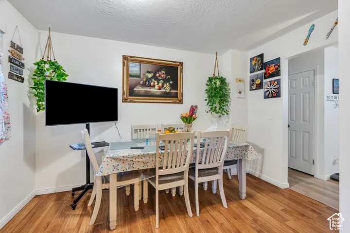 Room featuring wood-finish flooring and a multi-panel door