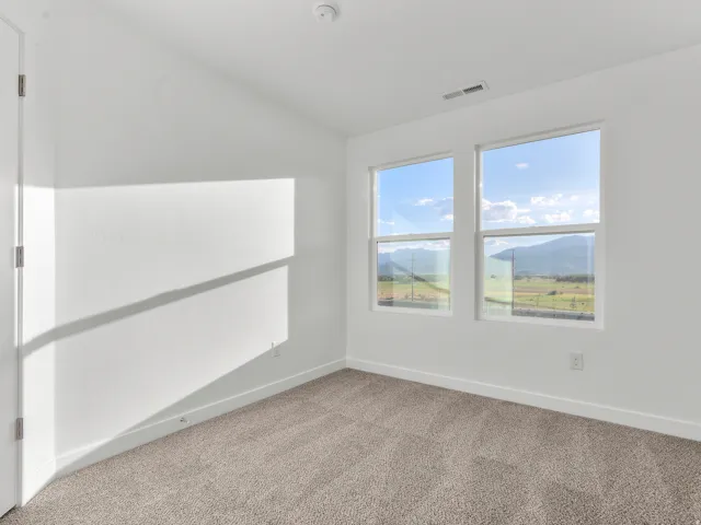 White interior walls with neutral carpeting