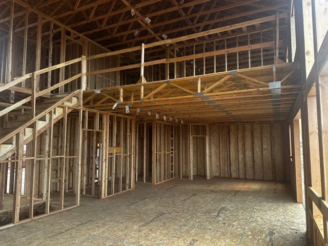 Open-concept framing with a visible second-story loft