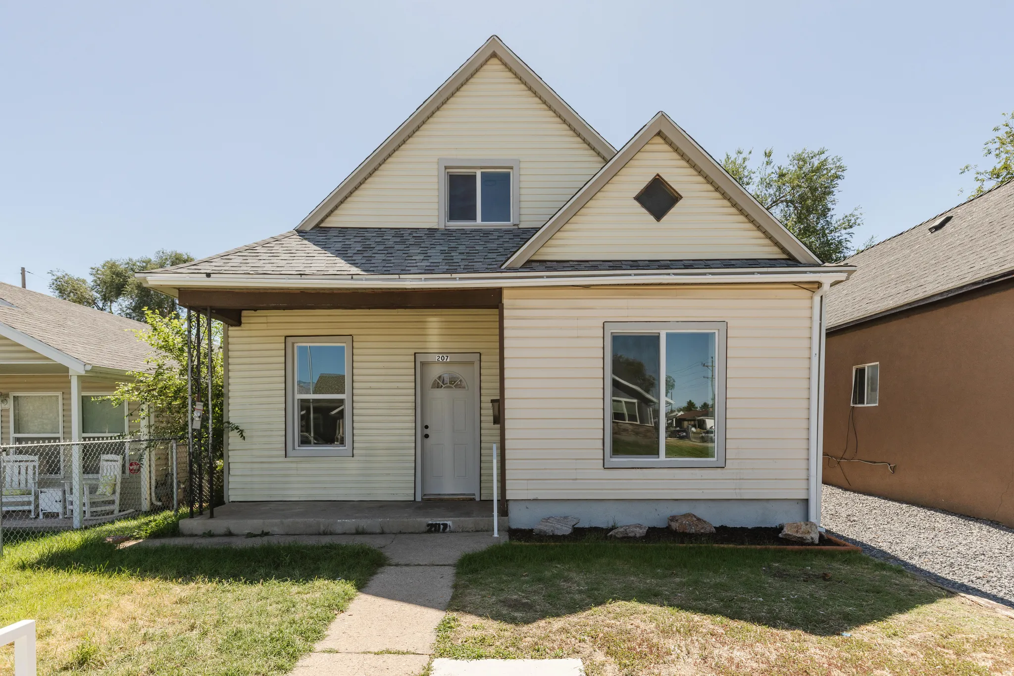 Gabled roofline home with light-colored siding