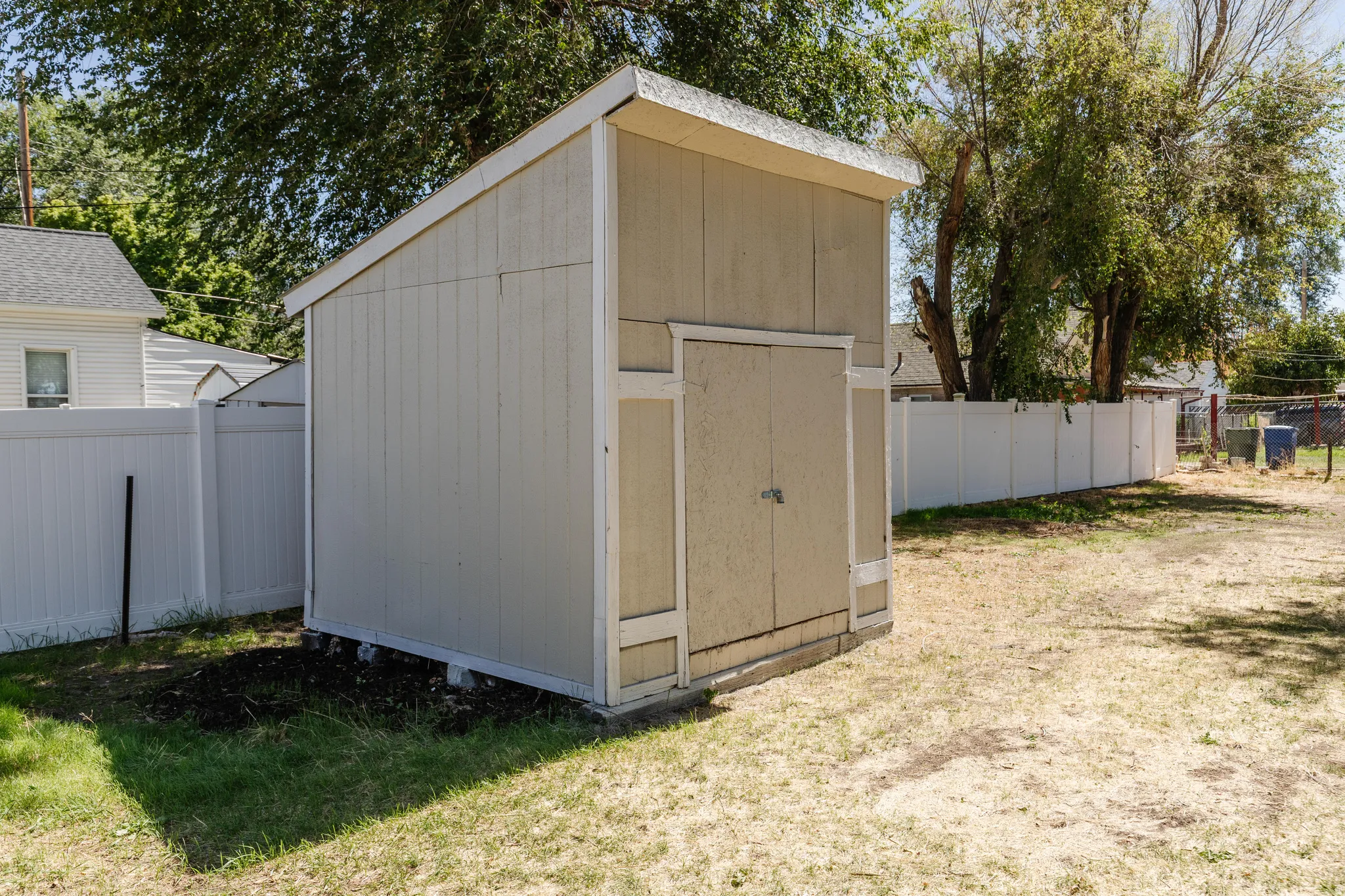Storage shed with a single-pitch roof and a double-door entry