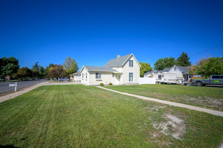 Traditional-style residence featuring a prominent gable roofline and a light-colored exterior