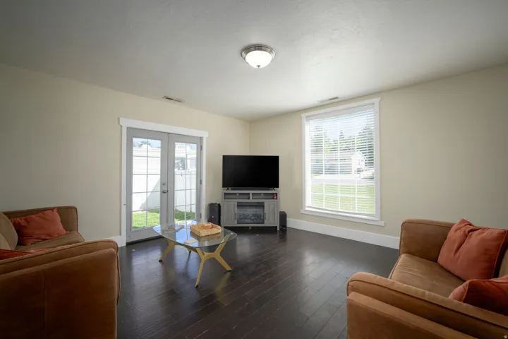 Dark wood-finish flooring with light-toned walls