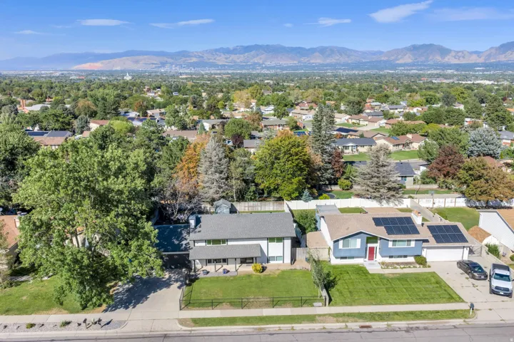 Expansive neighborhood featuring mature trees and distant mountains