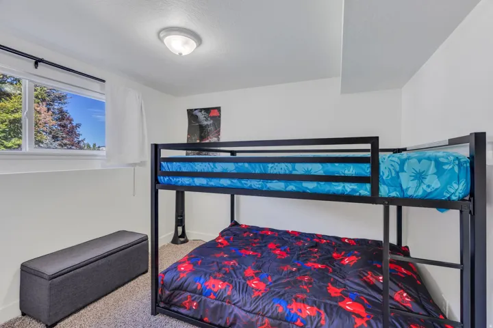 White walls, ceiling-mounted light fixture, and window with white trim