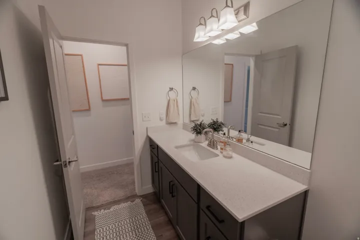 Extended vanity with an integrated sink, light-toned countertop, and dark-toned cabinetry