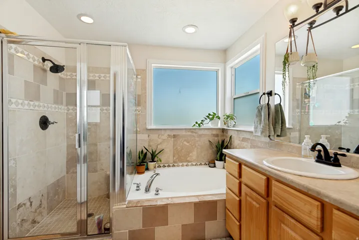 Owners suite with separate soaking tub and glass-enclosed shower.