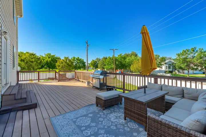 Expansive outdoor deck with wood-finish flooring and a wood-slat railing