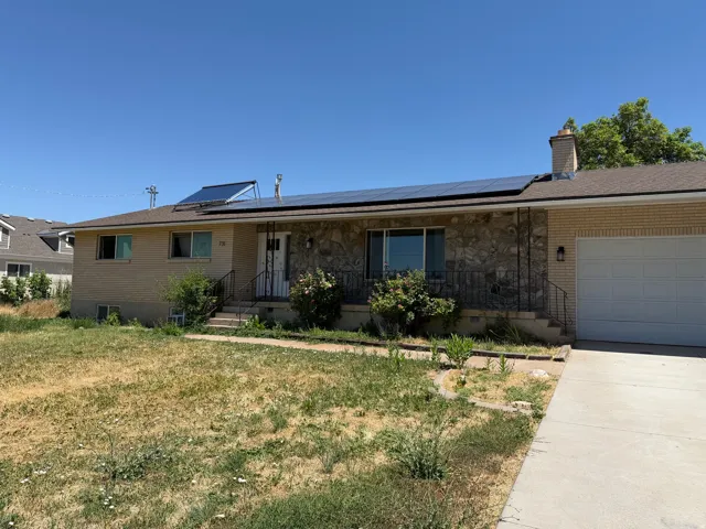 Brick and stone exterior with a concrete driveway