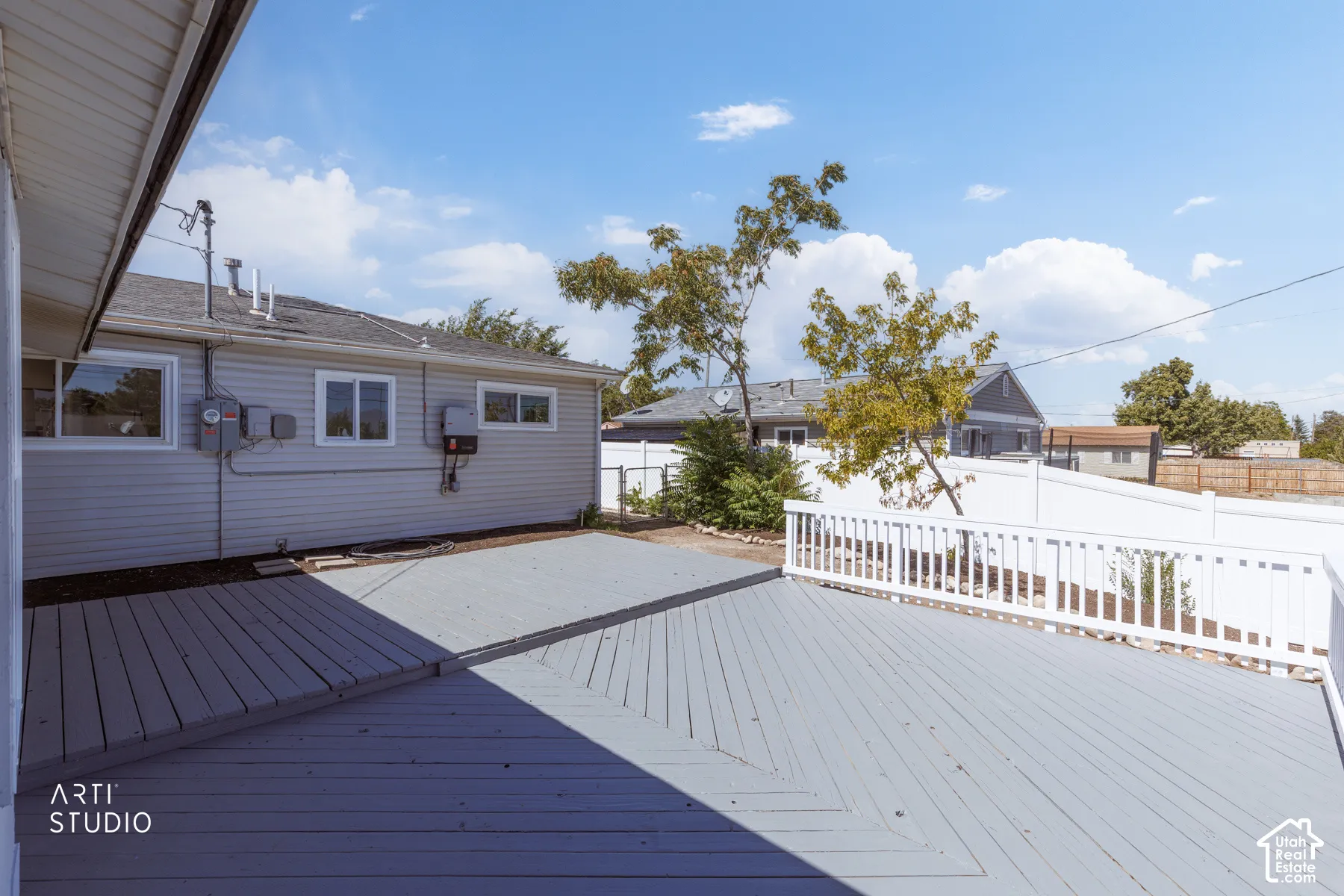 Expansive wood deck with a white railing