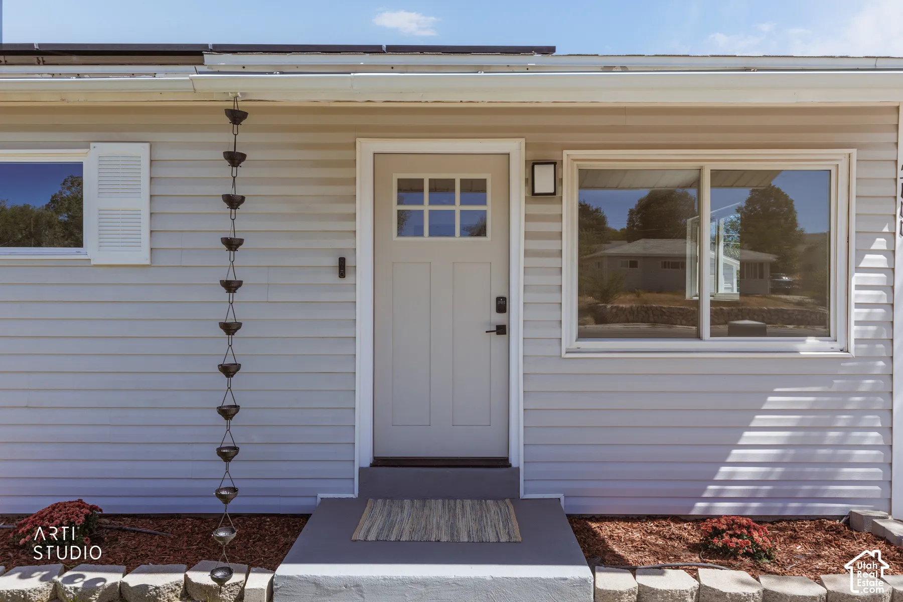 Light-toned horizontal siding with white trim