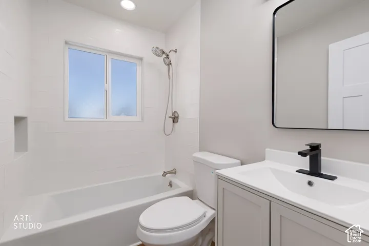White subway tile surround with integrated niche, modern vanity with white countertop, black-framed mirror, and black matte faucet