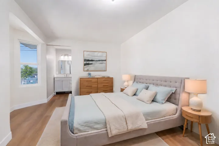 Recessed lighting, wood-finish flooring, and a white framed window