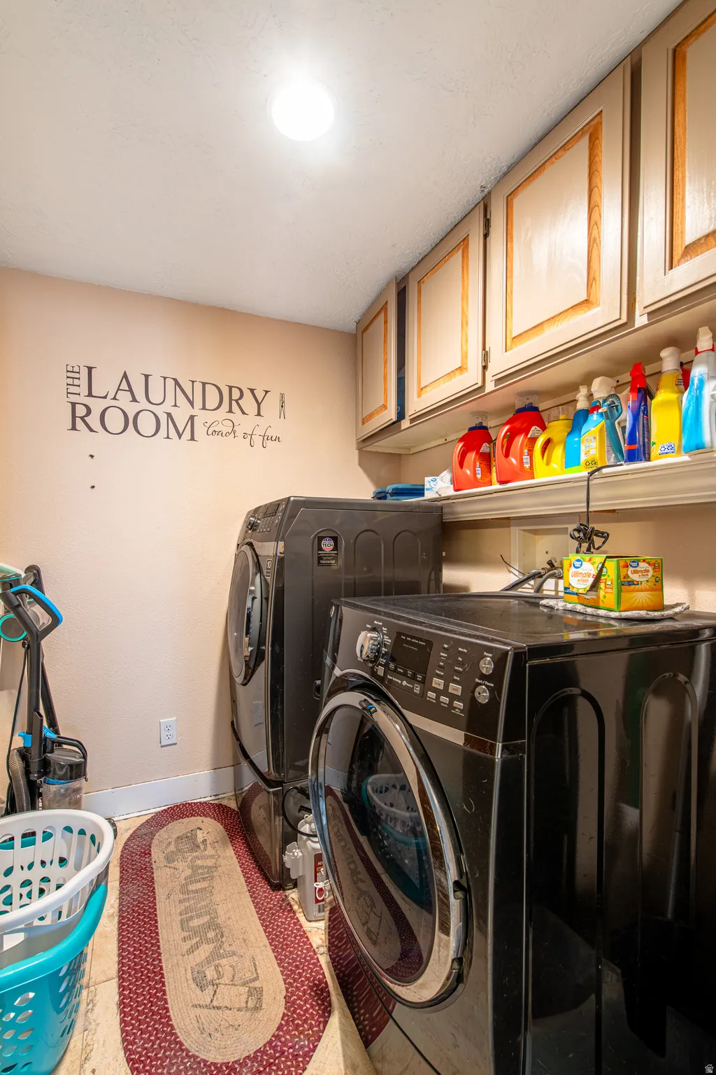 Upper cabinetry with light-colored doors and contrasting trim, accompanied by a built-in shelf