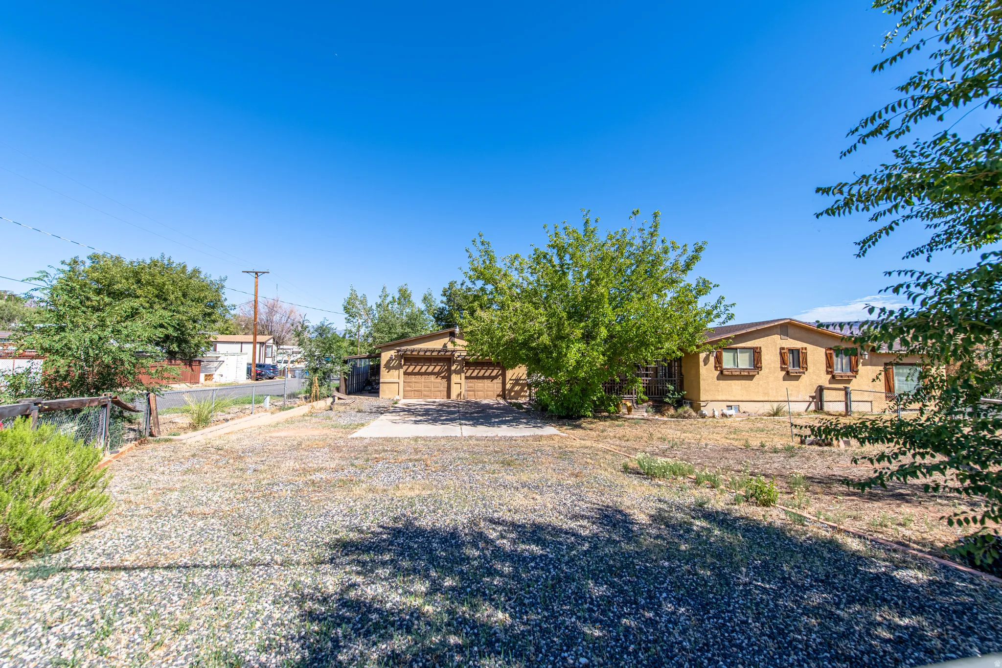 Gravel yard with mature trees
