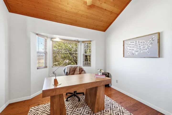 Vaulted wood-finish ceiling, bay window, wood-finish flooring, white walls, and recessed lighting