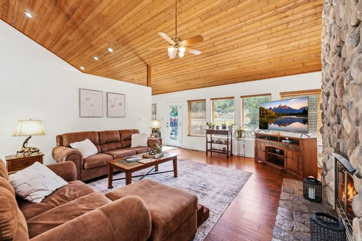 Wood-finish vaulted ceiling with exposed beams and recessed lighting