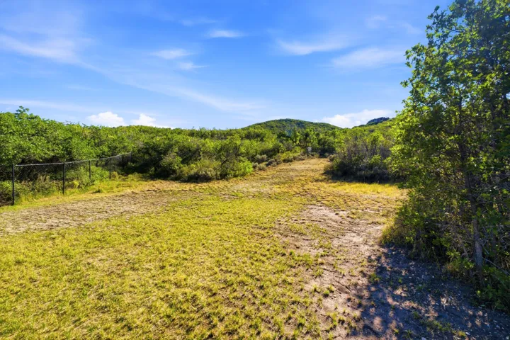 Expansive land featuring natural terrain and lush greenery