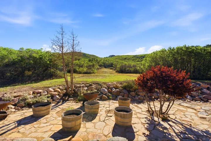 Stone patio featuring a natural rock border