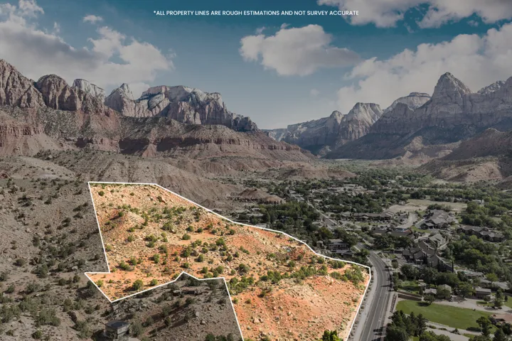 Mountainous terrain and surrounding valley, featuring a prominent roadway and natural landscaping