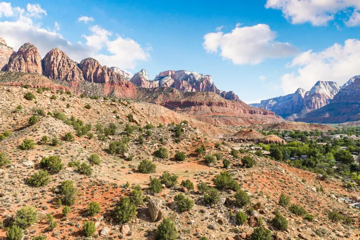 Expansive terrain featuring natural rock formations and scattered green foliage