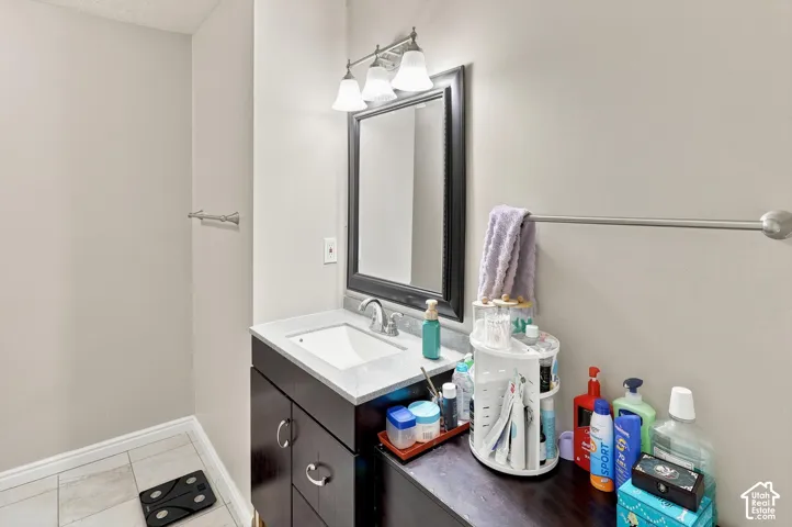 Dark wood vanity with a white rectangular undermount sink and light countertop