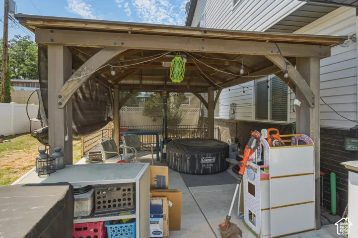 Covered patio structure with a wood-finish frame and screening