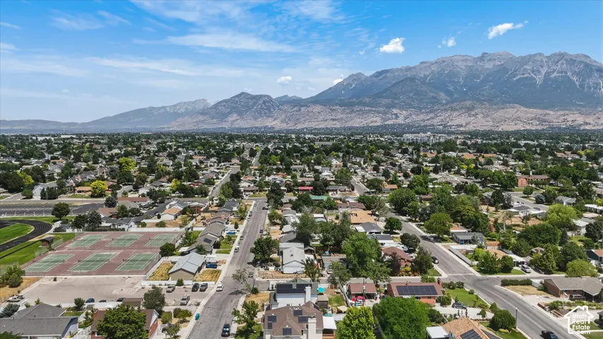Expansive residential area with mountain backdrop, established street grid, and mature tree canopy