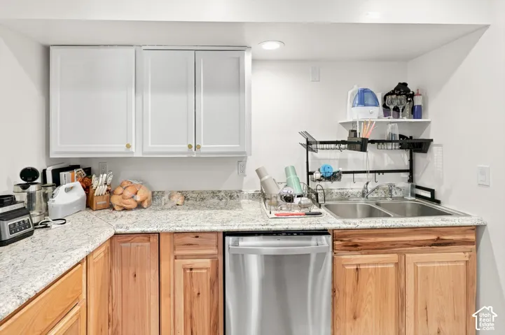 White upper cabinetry with gold hardware