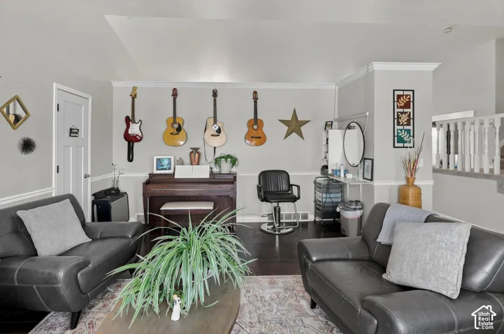 Dark wood-finish flooring with light gray walls, white trim, and a white interior door
