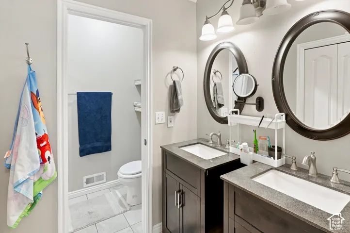 Dual vanities with integrated sinks and stone countertops