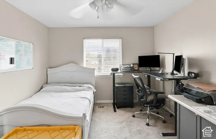 Recessed window with blinds, ceiling fan, carpeted flooring, and neutral wall tones