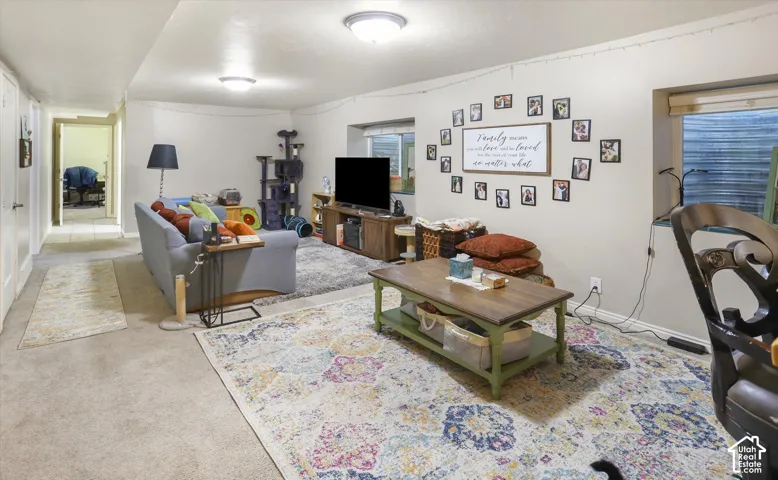 Recessed lighting, light-toned walls, and carpet flooring in a spacious room